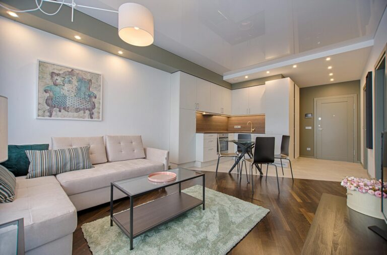 Residential Cleaning Services in Malta Spacious modern living room featuring chic furniture, stylish decor, and a minimalist kitchen.