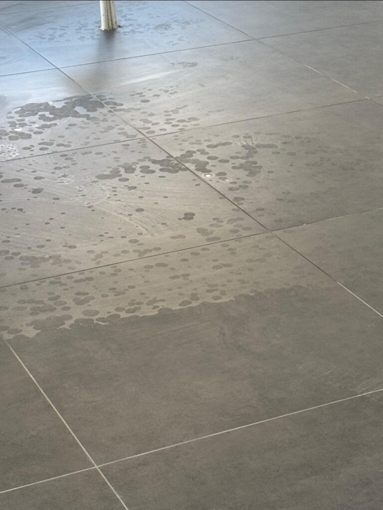 Floor tiles damaged by acid
